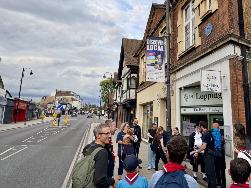 Scouts, Explorers, Leaders and UpStage members welcome Alex Beament to Lopping Hall in Loughton after his 160-mile walk