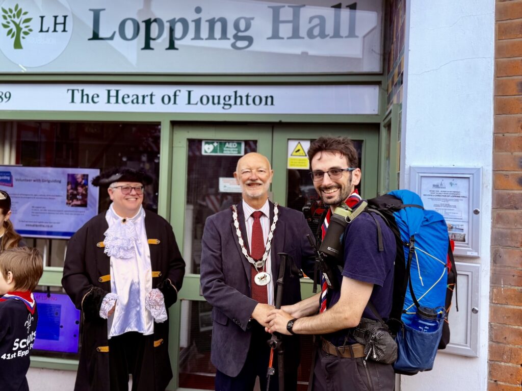 Alex Beament welcomed by Loughton Town Mayor Cllr Stephen Harriman at Lopping Hall after completing the 160-mile Whittington Way charity walk.